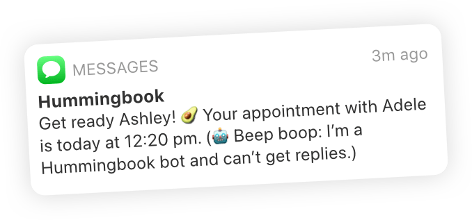 A text reminder that says ”Get ready Ashley! 🥑 Your appointment with Adele is today at 12:20 pm. (🤖 Beep boop: I’m a Hummingbook bot and can’t get replies.)”
